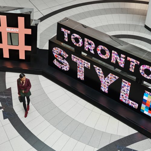 girl infront of #torontostyle sign